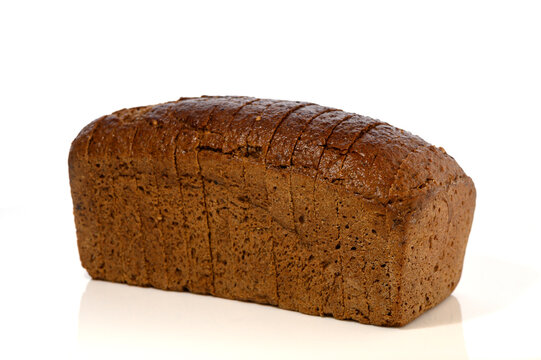 Commercial stock photo of a sliced loaf of dark brown rye bread isolated on white