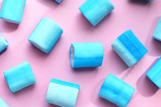 Multicolored marshmallows. Background or texture of blue and pink marshmallows. Blue marshmallows on a pink background.