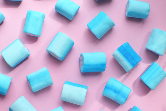 Multicolored marshmallows. Background or texture of blue and pink marshmallows. Blue marshmallows on a pink background.