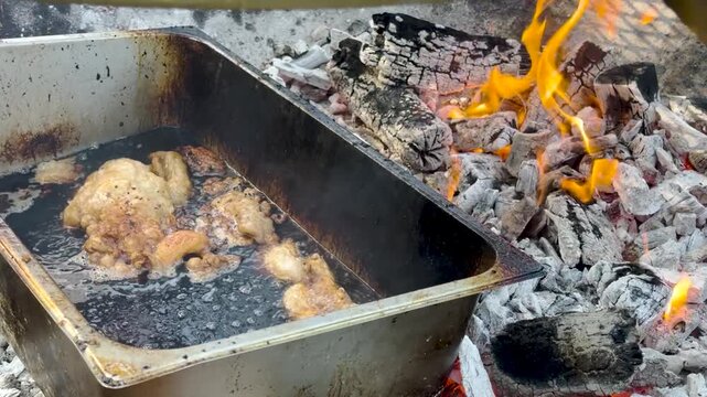Close-up video footage of a chef wearing black gloves using a sharp knife to slice freshly smoked barbecue meat on butcher paper.
