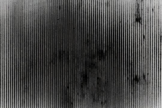Abstract monochrome of parallel lines with subtle texture and dark smudges