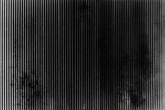 Close-up of textured vertical lines with a dusty, smudged appearance