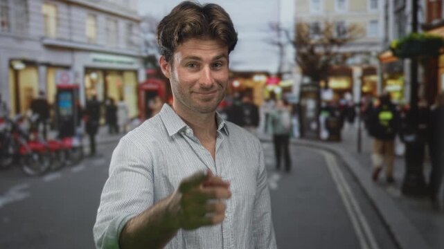 Man pointing finger to camera on busy city street, smirking with visible hand extended toward viewer; confidence invitation.