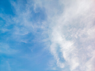 Soft clouds drift across a clear blue sky. Lightness and calm fill the atmosphere. Ideal for backgrounds or tranquil mood themes. Perfect for design projects needing serenity © Insyafotoiniitu