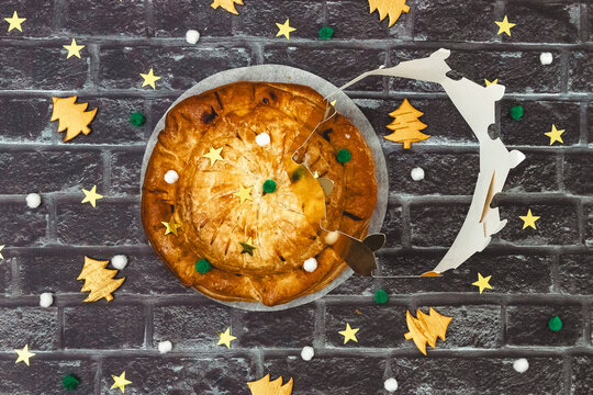 Homemade round royal galette with a crown and festive decor.