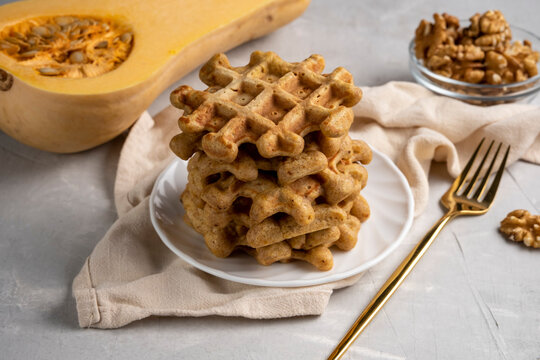 Sweet baked pumpkin waffles on a plate on the table