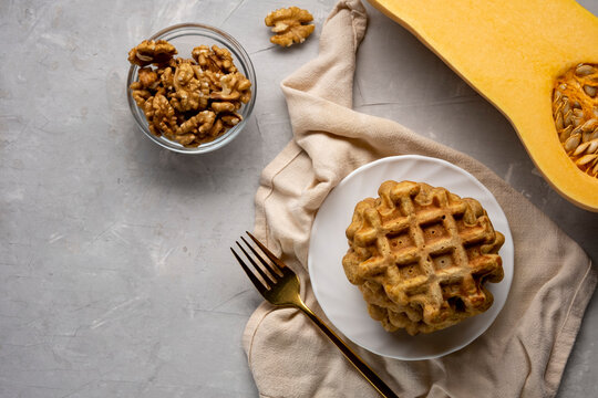 Sweet baked pumpkin waffles on a plate on the table