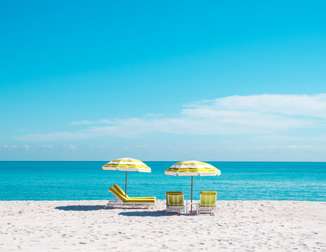 yellow beach umbrella and lounge chair in miami florida