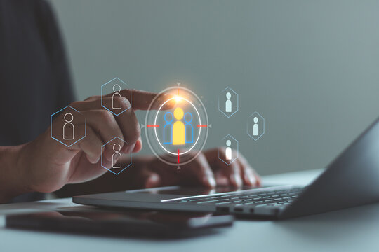 Businessman use laptop with target customer icons for customer focus group. Targeting customer concept, Digital marketing online, CRM, Data exchanges development and customer service.