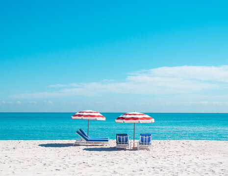 red white and blue beach umbrella and lounge chair in miami florida