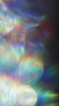 Dreamy bokeh of reflective shimmer with a dazzling shine and gleam of rainbow lens rays. Shining reflections creating visual of magical glittering lights and a glowing aura of iridescent colors. Loop