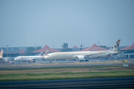 Tangerang, Indonesia - August 22, 2026: An Etihad Airways Boeing 787 Dreamliner moves along the runway under a hazy sky during the dry season at Soekarno-Hatta International Airport.
