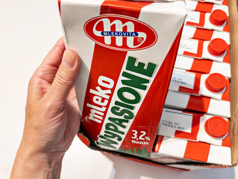 WARSAW, POLAND - MAY 7, 2026: Hand taking Mlekovita Wypasione milk from box