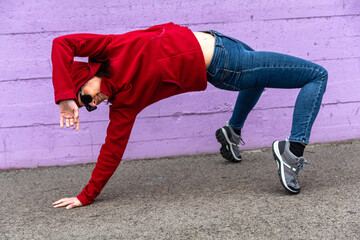 Fototapeta premium Woman performing yoga bridge pose in urban setting