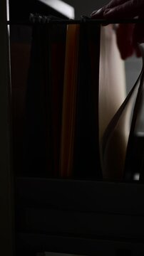 Cinematic noise vertical video Office space file folders cabinet searching for documents, textured backgrounds copy space, bokeh abstract close up