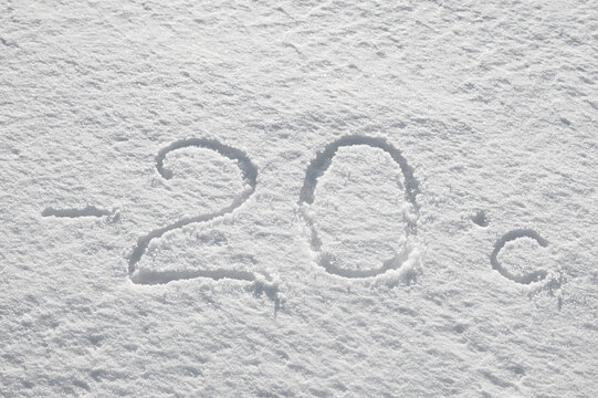 Background with snow, photo of snow texture in winter and numbers indicating that the temperature is -20 degrees Celsius
