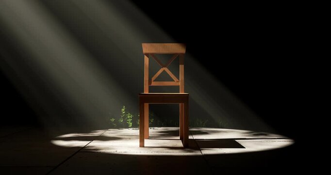 Wooden chair illuminated by dramatic spotlight with moving shadows in dark empty room