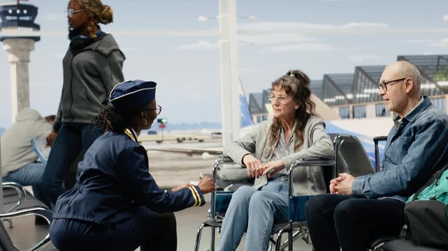 Cabin crew staff gives directions and helps an elderly woman using a wheelchair with boarding pass and gate information for accessible retirement travel.