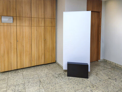 Modern interior with wood panel cabinets, white display panel, black base, and tiled floor