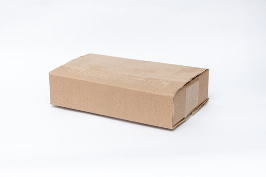Plain kraft cardboard box isolated on a white background for shipping and packaging