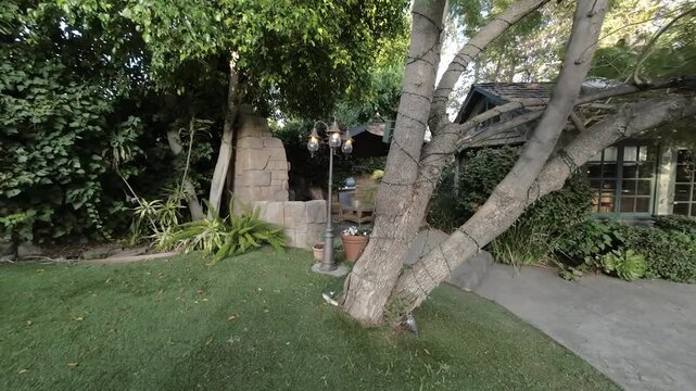 Moving through a backyard garden to a wicker patio lounge area