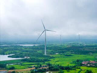 Wind turbine over fields with ponds in China - renewable energy © ZTC Studio