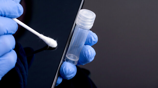 Sample collection using cotton swab and test tube on dark background, diagnostic testing.