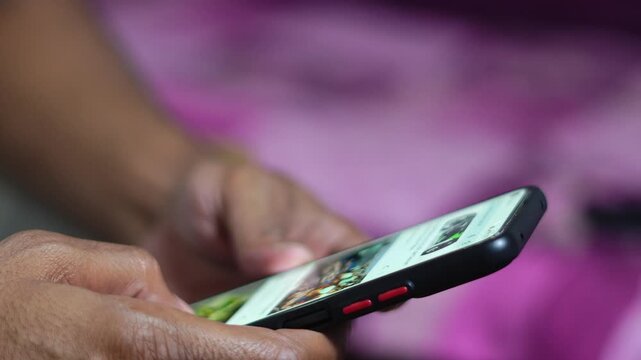 Close up of person scrolling on social media using smartphone