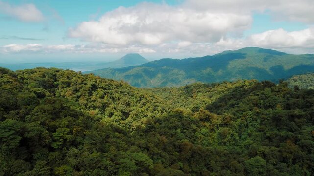 Lush Monteverde cloud forest with distant volcanic peaks in tropical Costa Rica