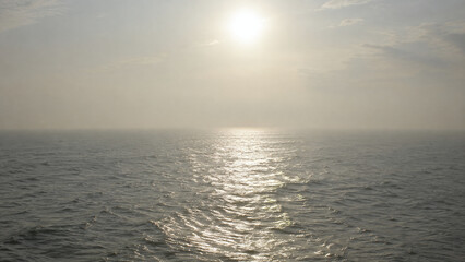 Fototapeta premium Hazy Sunlight Shimmering Across the Open Sea
