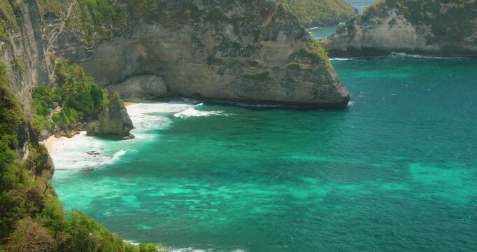 Secluded beach and dramatic limestone cliffs along Diamond Beach in Nusa Penida Bali