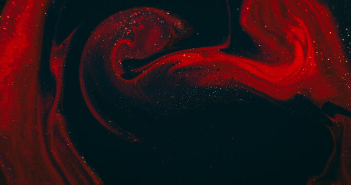 Shiny ink. Acrylic flow. Defocused red purple color mix sparkling texture glitter fluid floating on abstract art background.