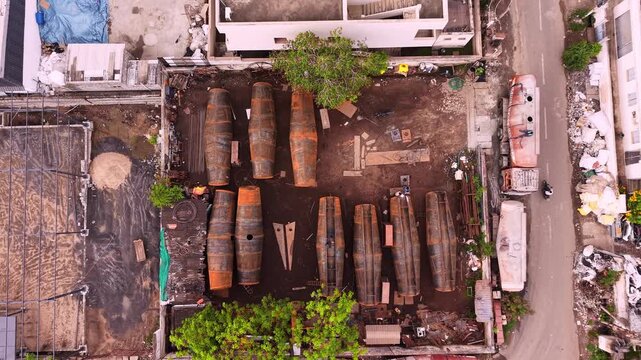 Steel storage tanks laid out at industrial tank fabrication and manufacturing yard aerial