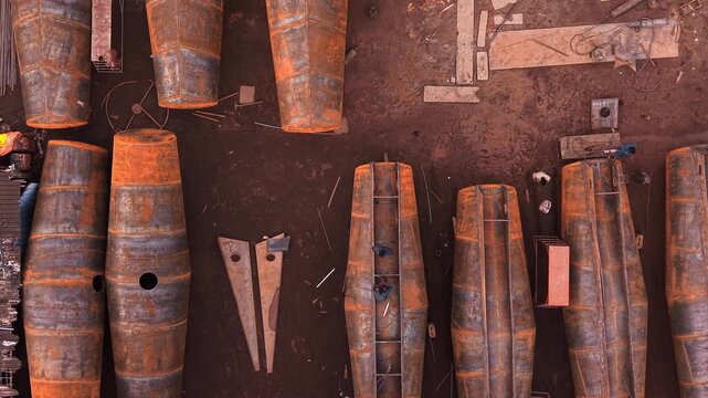 Top down rows of cylindrical steel tanks at industrial tank fabrication manufacturing yard