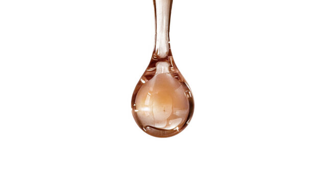 A single golden liquid droplet suspended in mid-air against a plain transparent background.