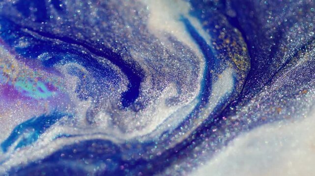 Glitter art fluid. Ink transition. Purple blue liquid stream mix color in white shiny acrylic abstract texture defocused flare background.
