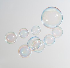 Obraz premium Colorful soap bubbles floating on white background