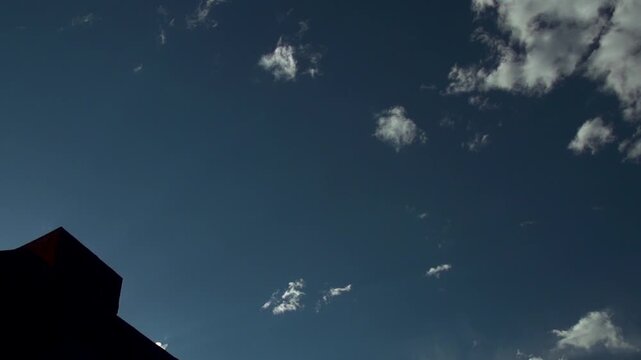 Slow motion silhouette of mountain bike rider doing tricks in the air