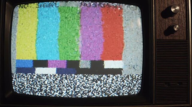 Glitchy Analog Television No Signal Test Bars - A vintage television screen displays the familiar color bars of a "no signal" test pattern.