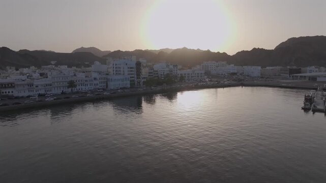 Aerial Evening View of Mutrah Corniche Muscat Oman with Hajar Mountains