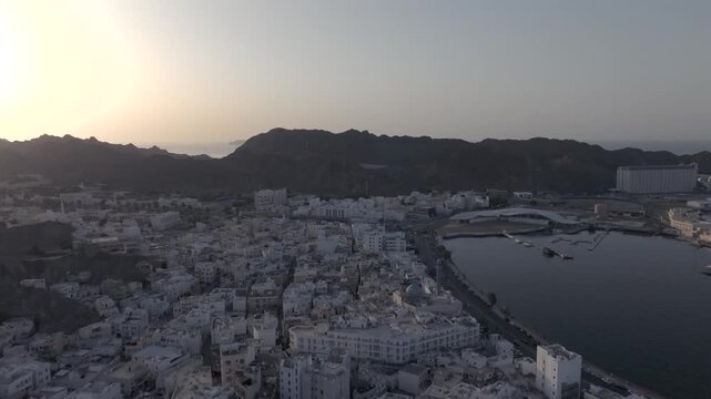 Aerial Evening View of Mutrah Corniche Muscat Oman with Hajar Mountains