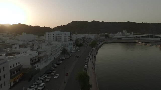 Aerial Evening View of Mutrah Corniche Muscat Oman with Hajar Mountains