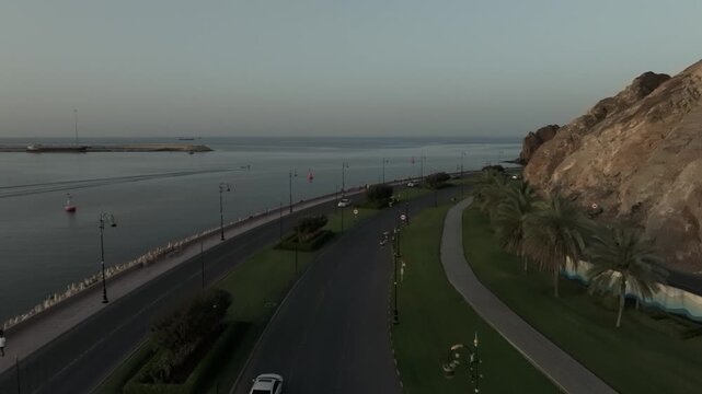 Aerial Evening View of Mutrah Corniche Muscat Oman with Hajar Mountains