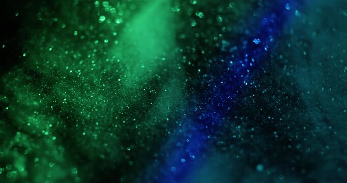 Blur glimmer light. Dazzle bokeh. Defocused blue green neon color illuminated radiant glitter rainbow on abstract dark black visual background.