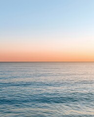 Fototapeta premium Abstract ocean horizon with pale gradient sky showcasing varied depths during sunset