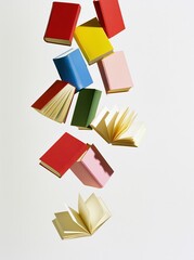 Obraz premium Colorful books floating in white space