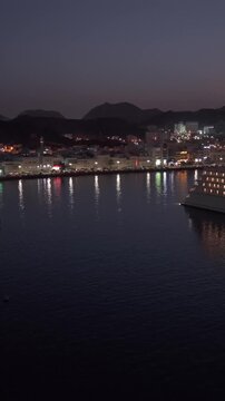 Vertical Aerial Night View of Mutrah Corniche Muscat Oman Waterfront and City Lights
