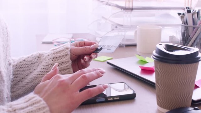 Mobile commerce. Internet banking. Unrecognizable business female typing information on smartphone using credit card for digital transfer in office.