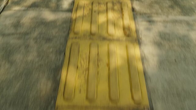 Yellow tactile paving guiding visually impaired pedestrians