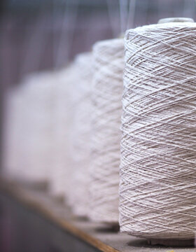 White Cotton Yarn Spools in Textile Industry